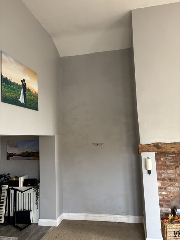 Damp patches and blown plaster on internal wall