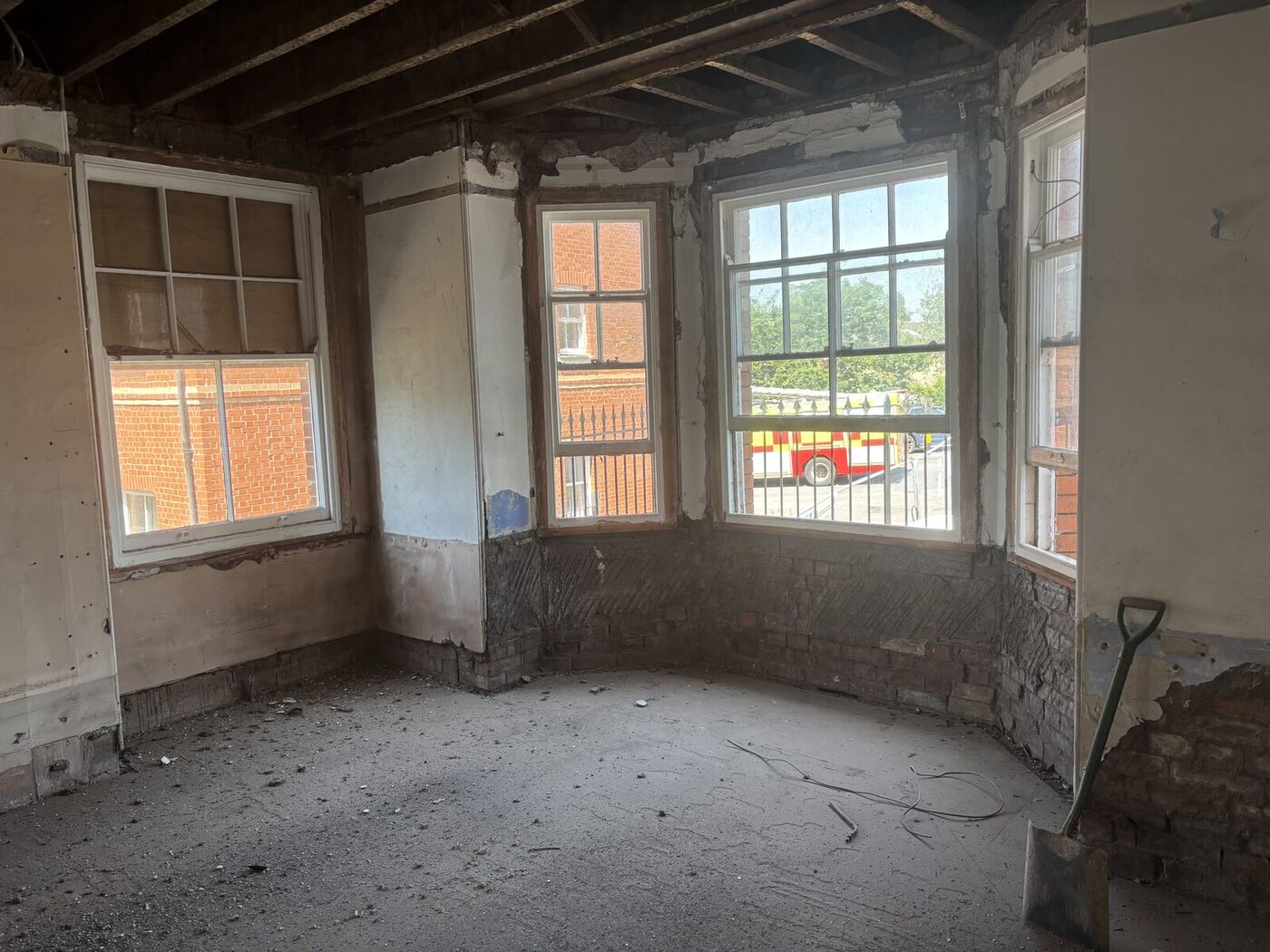 Gutted bay window room, exposed brickwork