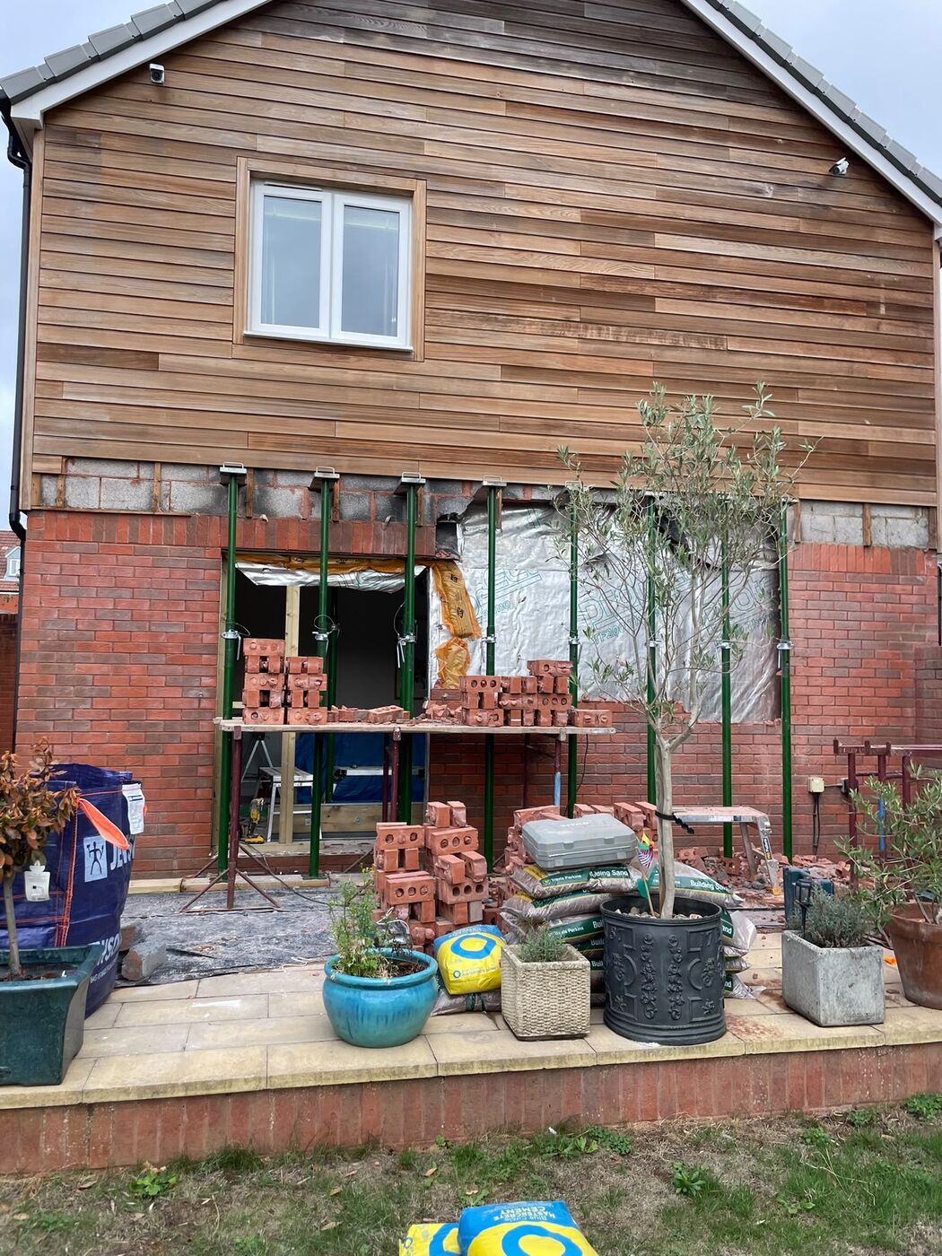 Rear elevation with the opening propped and brickwork being rebuilt
