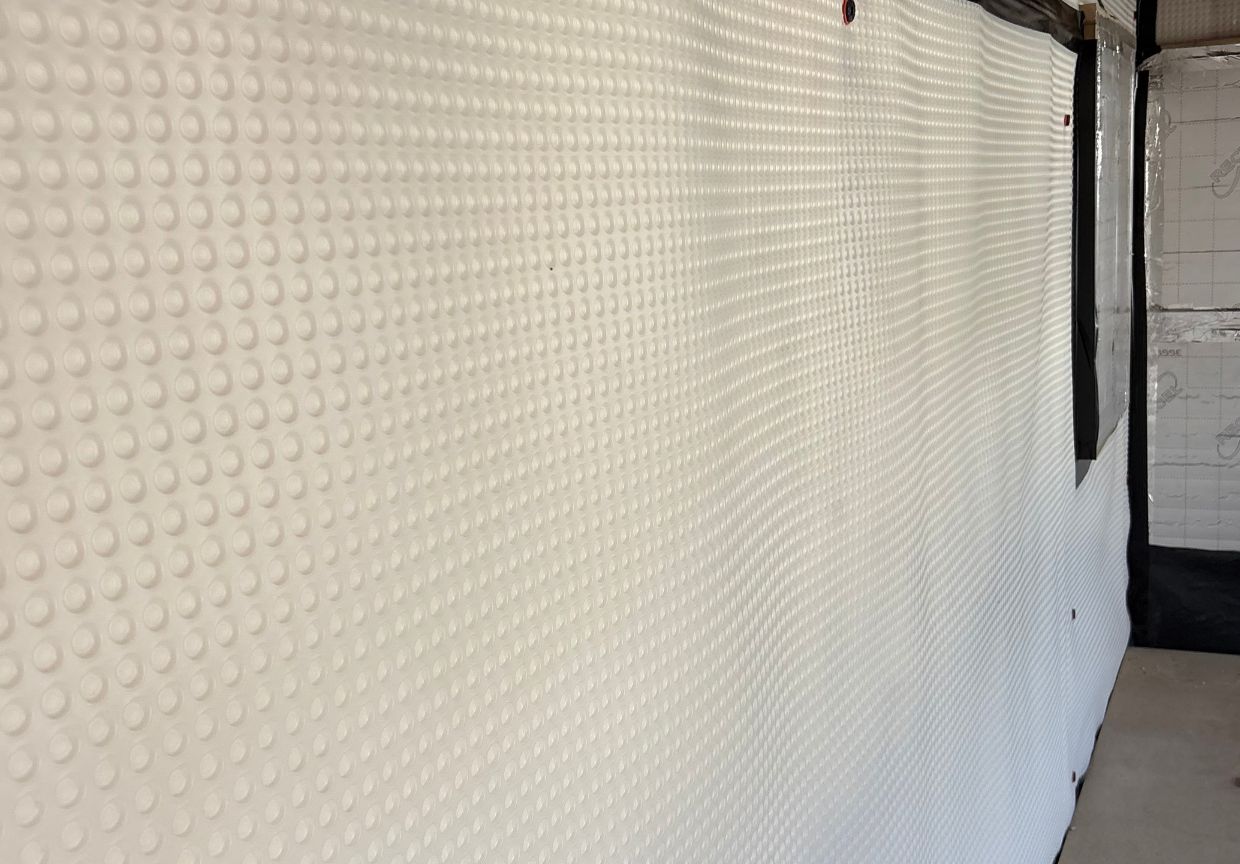 Damp proof membrane fixed to an internal wall