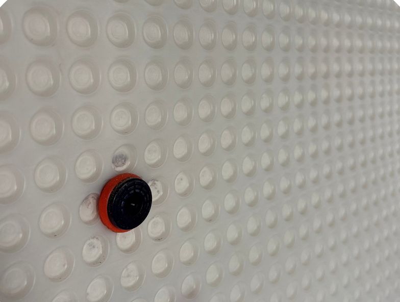 Close-up of the studded damp proof membrane and fixing plug