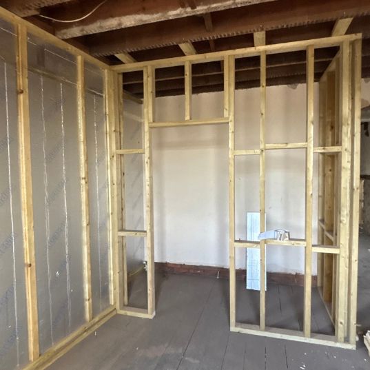 New timber studwork partitions formed in a stripped room