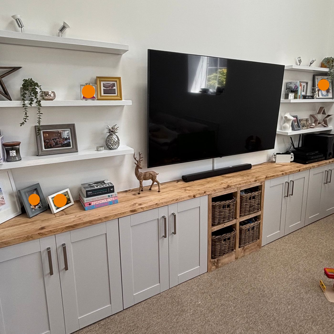 Completed media wall with cupboards, worktop and floating shelves