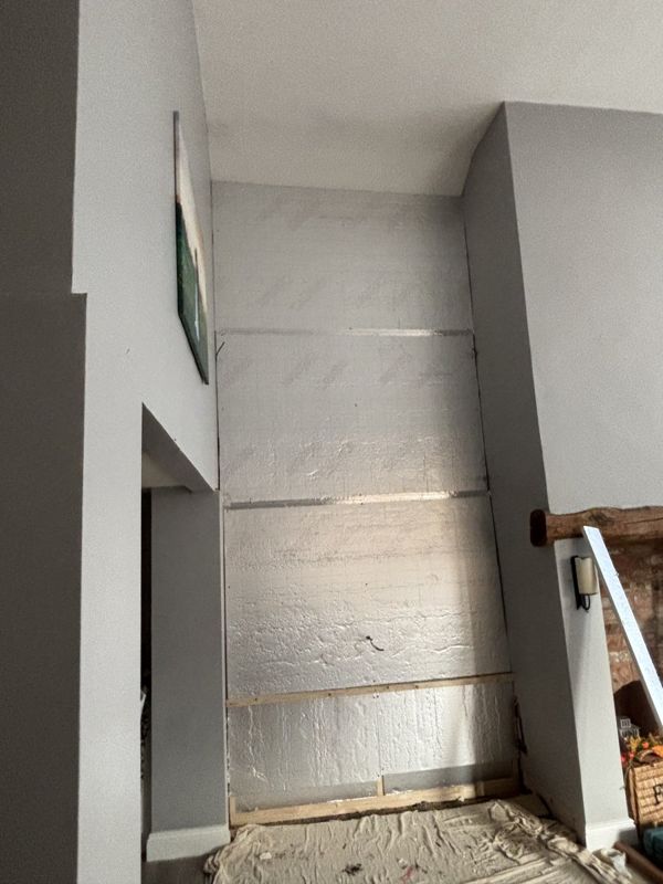 Insulation boards fitted to alcove wall